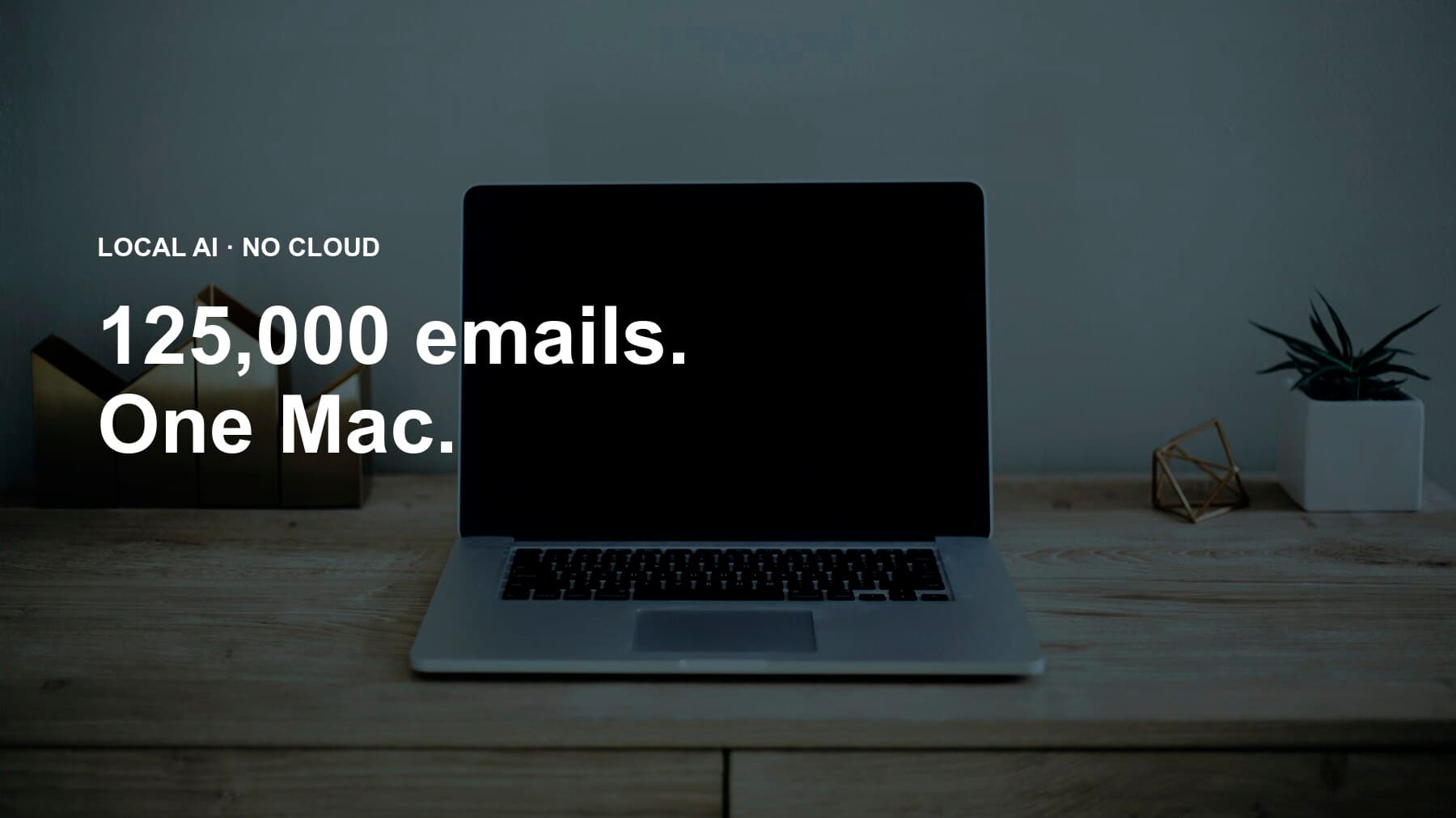 A MacBook on a wooden desk under a navy tint, with the overlay text "Local AI · No cloud, 125,000 emails. One Mac." in white.